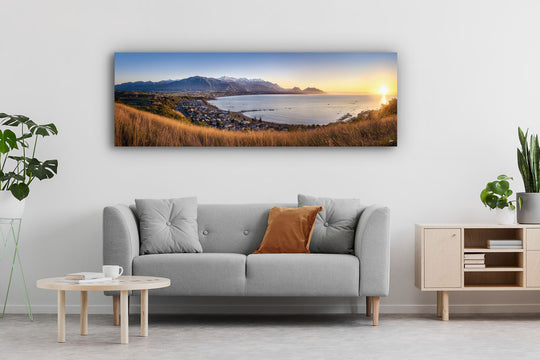 Canvas photo wall art of a New Zealand landscape with a grey couch, plants and table.