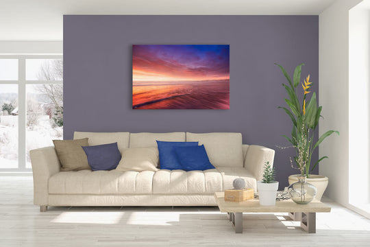 New Zealand landscape canvas photo wall art in lounge setting with a grey wall, white couch, coffee table, plant, cushions