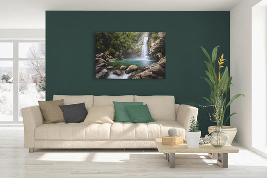 New Zealand landscape canvas photo wall art in lounge setting with a green wall, white couch, coffee table, plant, cushions