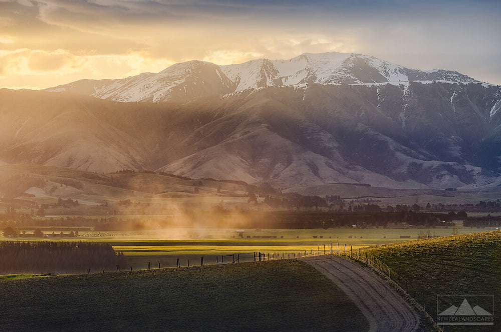 Sun setting behind mountains near Geraldine. Buy a photo print or canvas print for your wall.