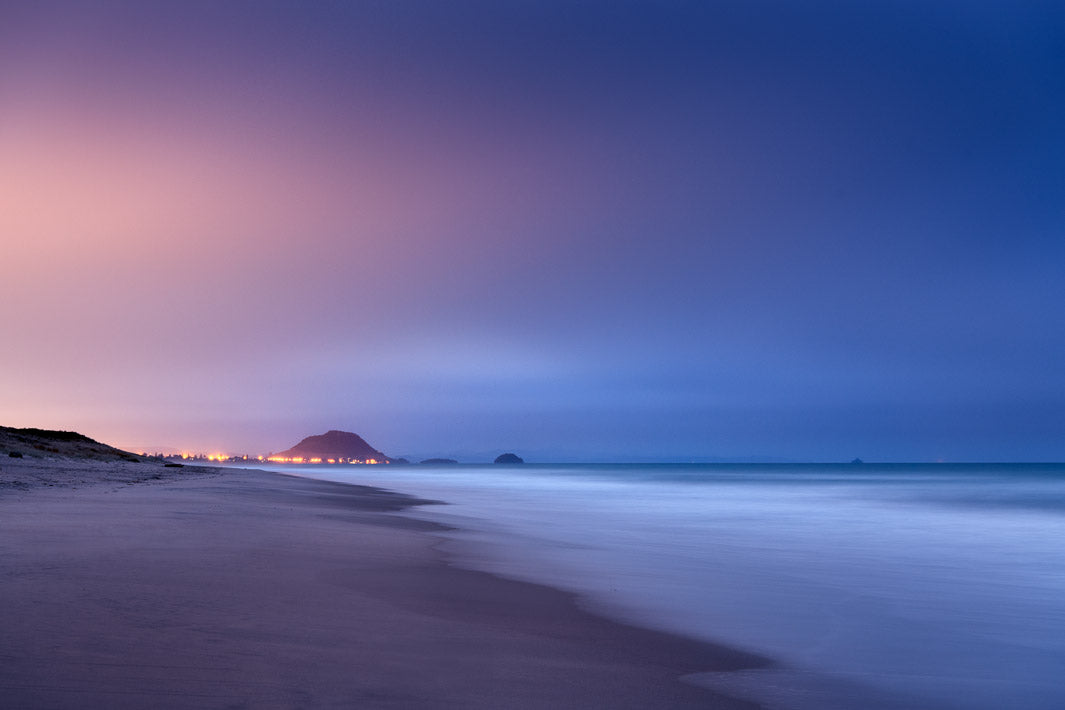 Night landscape photo looking toward Mount Maunganui in the distance, from Papamoa Beach.